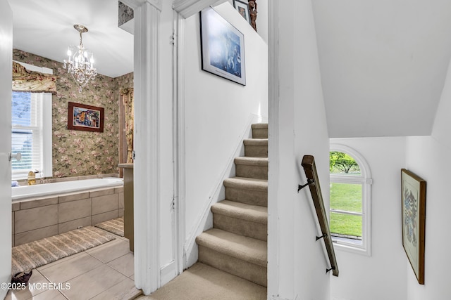 75 Portland Rd, Highlands, NJ 07732 - stairs with wallpapered walls, a chandelier, and tile patterned flooring