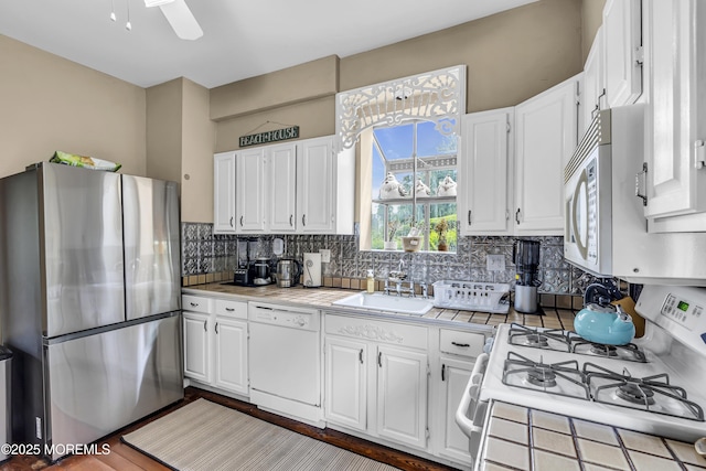 75 Portland Rd, Highlands, NJ 07732 - kitchen featuring white appliances, white cabinets, backsplash, tile countertops, and ceiling fan