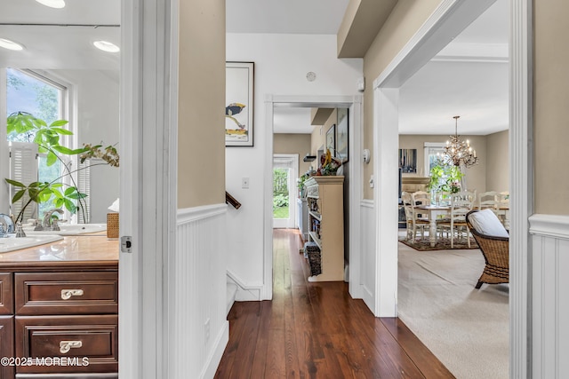 75 Portland Rd, Highlands, NJ 07732 - corridor with a wainscoted wall, healthy amount of natural light, dark wood-style floors, a chandelier, and a decorative wall