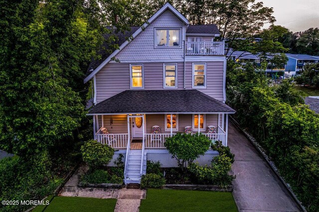 75 Portland Rd, Highlands, NJ 07732 - victorian house featuring covered porch, stairs, roof with shingles, a balcony, and a front lawn