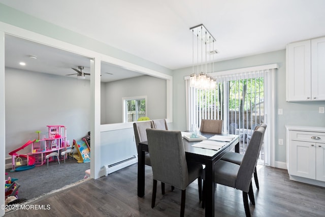 629 Alpine St, Forked River, NJ 08731 - dining area with dark wood-type flooring, a baseboard heating unit, a chandelier, a ceiling fan, and baseboards