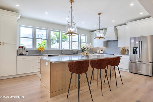 205 Parkway Pt, Pleasant Beach, NJ 08742 - kitchen with stainless steel appliances, custom range hood, a center island, backsplash, and light wood finished floors