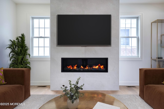 205 Parkway Pt, Pleasant Beach, NJ 08742 - living area featuring a large fireplace, wood finished floors, and healthy amount of natural light
