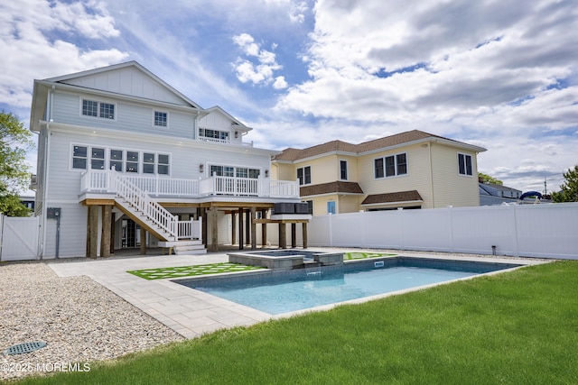 205 Parkway Pt, Pleasant Beach, NJ 08742 - rear view of property with stairs, board and batten siding, a deck, a pool with connected hot tub, and a gate