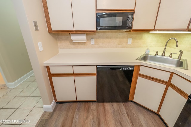 2708 Ridgefield Ct Unit 2708, Helmetta, NJ 08828 - kitchen featuring dishwasher, black microwave, a sink, light countertops, and tasteful backsplash