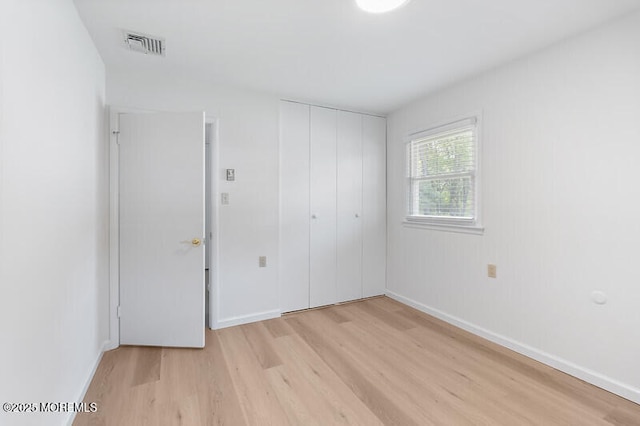 8 Holmes Ct, Brick, NJ 08724 - unfurnished bedroom featuring light wood finished floors and a closet