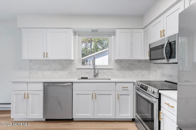 8 Holmes Ct, Brick, NJ 08724 - kitchen featuring appliances with stainless steel finishes, white cabinetry, light countertops, and decorative backsplash