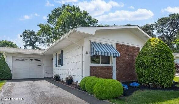 8 Holmes Ct, Brick, NJ 08724 - view of property exterior featuring asphalt driveway, an attached garage, and brick siding