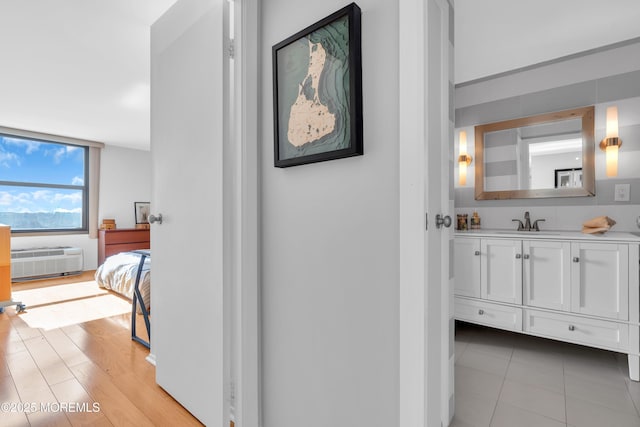 1 Scenic Dr Unit 511, Highlands, NJ 07732 - hallway with a sink, an AC wall unit, and light tile patterned flooring