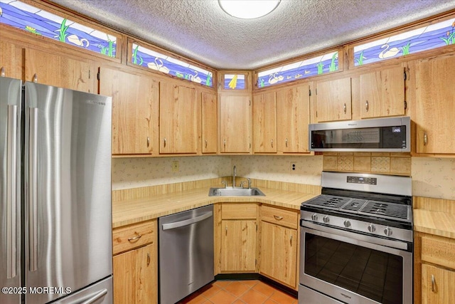5-3 Portland Ct, Freehold, NJ 07728 - kitchen with appliances with stainless steel finishes, a sink, a textured ceiling, light tile patterned floors, and tile countertops