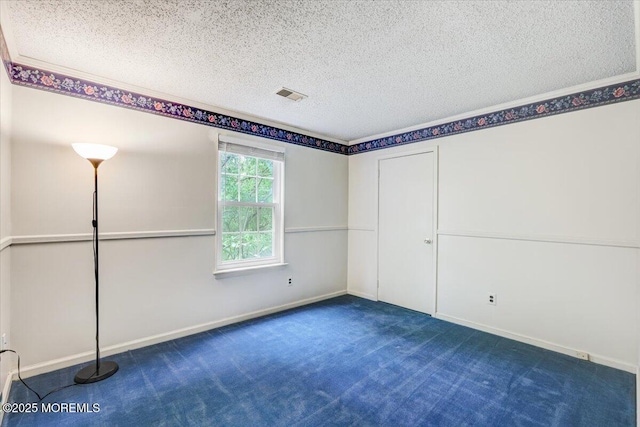 5-3 Portland Ct, Freehold, NJ 07728 - spare room featuring a textured ceiling, dark colored carpet, and baseboards