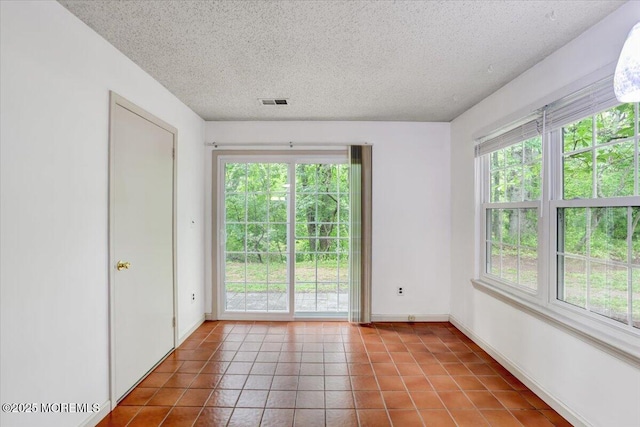 5-3 Portland Ct, Freehold, NJ 07728 - spare room with healthy amount of natural light, a textured ceiling, tile patterned floors, and baseboards
