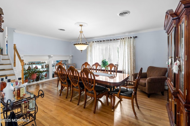 660 Summit Ave, Kenilworth, NJ 07033 - dining space with ornamental molding, light wood-style flooring, and stairs