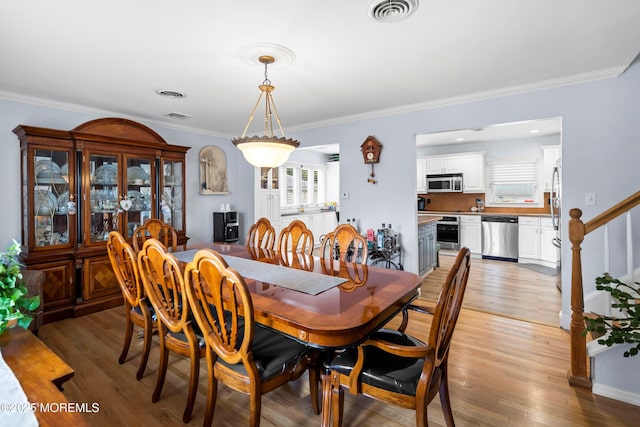 660 Summit Ave, Kenilworth, NJ 07033 - dining room with crown molding, light wood-style floors, and stairway