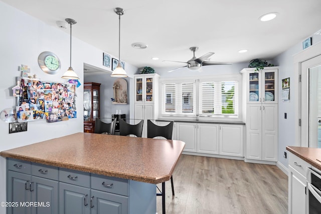 660 Summit Ave, Kenilworth, NJ 07033 - kitchen with a ceiling fan, white cabinetry, light wood-style flooring, glass insert cabinets, and recessed lighting