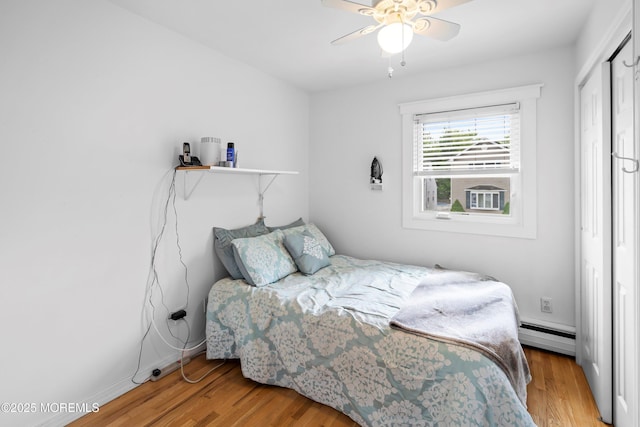660 Summit Ave, Kenilworth, NJ 07033 - bedroom featuring a baseboard radiator, wood finished floors, a closet, and a ceiling fan