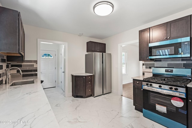 23 Stokes St, Freehold, NJ 07728 - kitchen with appliances with stainless steel finishes, a sink, dark brown cabinetry, light stone countertops, and tasteful backsplash