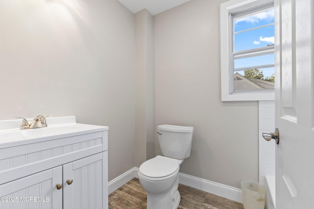 23 Stokes St, Freehold, NJ 07728 - bathroom with baseboards, toilet, wood finished floors, and vanity