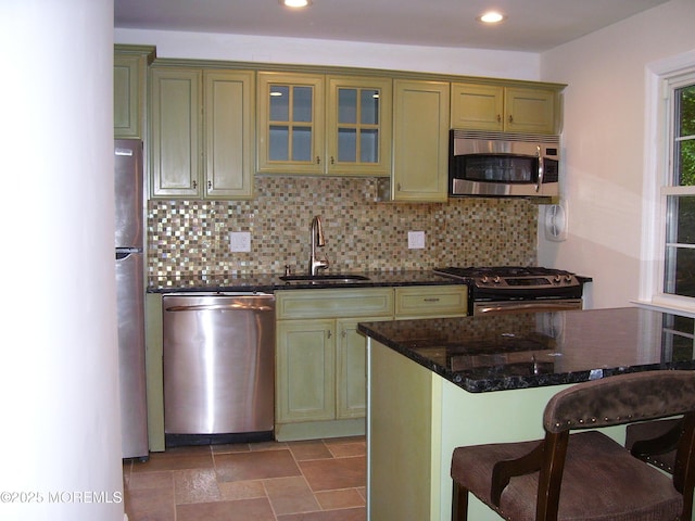 364 Westwood Ave Unit 12, Long Branch, NJ 07740 - kitchen featuring appliances with stainless steel finishes, a sink, a breakfast bar, tasteful backsplash, and recessed lighting