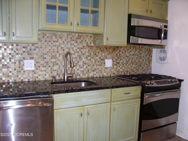 364 Westwood Ave Unit 12, Long Branch, NJ 07740 - kitchen featuring stainless steel appliances, a sink, cream cabinets, and decorative backsplash