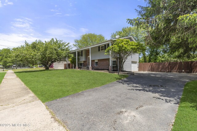 5 S Dakota Ave, Jackson, NJ 08527 - split foyer home featuring asphalt driveway, brick siding, and a garage