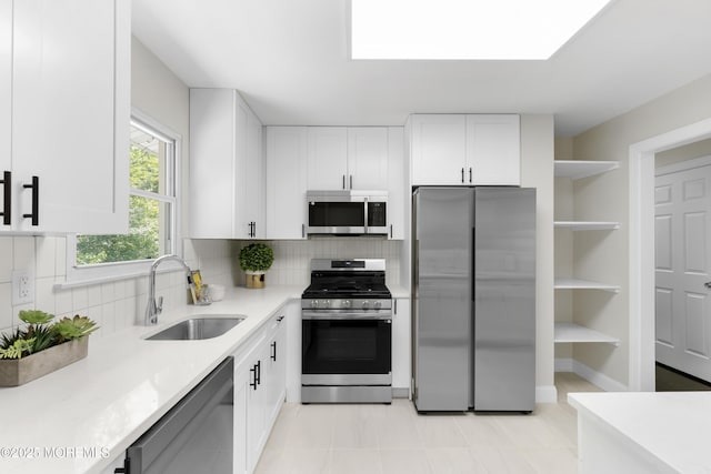 5 S Dakota Ave, Jackson, NJ 08527 - kitchen with appliances with stainless steel finishes, a sink, light countertops, white cabinetry, and tasteful backsplash