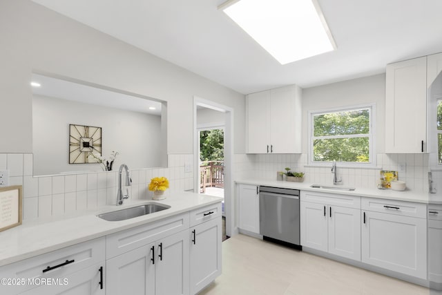 5 S Dakota Ave, Jackson, NJ 08527 - kitchen with a sink, stainless steel dishwasher, decorative backsplash, and white cabinets