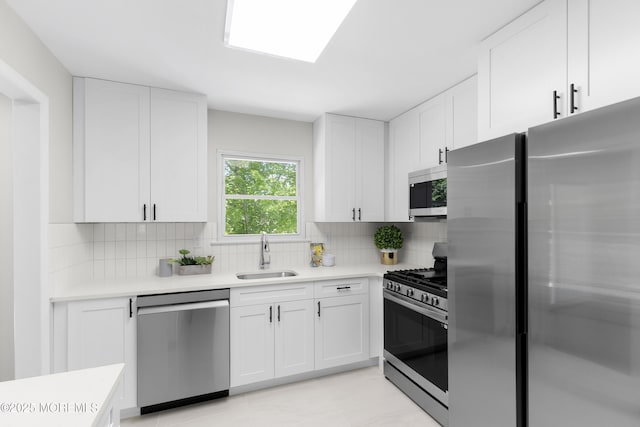 5 S Dakota Ave, Jackson, NJ 08527 - kitchen with stainless steel appliances, a sink, light countertops, white cabinetry, and tasteful backsplash