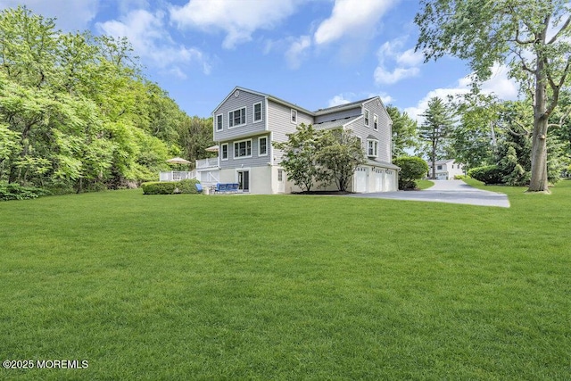 71 Maple Ave, Little Silver, NJ 07739 - back of property with an attached garage, asphalt driveway, and a yard