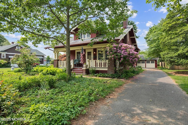 228 Albert Pl, Elberon, NJ 07740 - view of front of house with covered porch, a chimney, and a detached garage