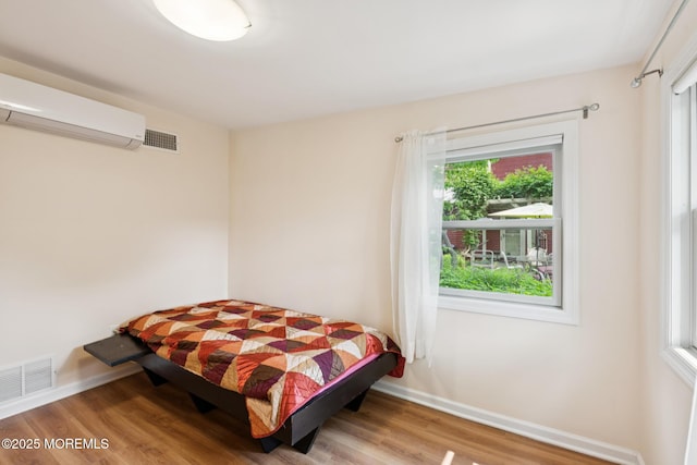 228 Albert Pl, Elberon, NJ 07740 - bedroom featuring a wall mounted AC, baseboards, and wood finished floors