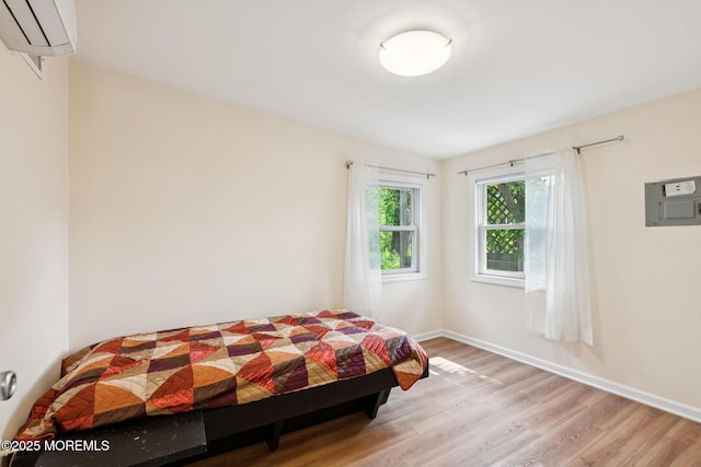 228 Albert Pl, Elberon, NJ 07740 - bedroom featuring a wall mounted AC, wood finished floors, baseboards, and electric panel