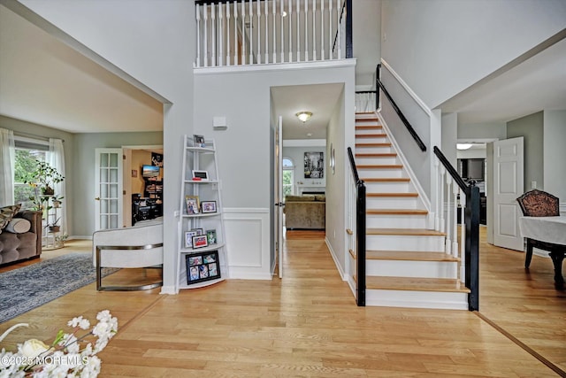 2 Hampton Hollow Dr, Perrineville, NJ 08535 - foyer with healthy amount of natural light, light wood finished floors, stairway, a high ceiling, and a wainscoted wall