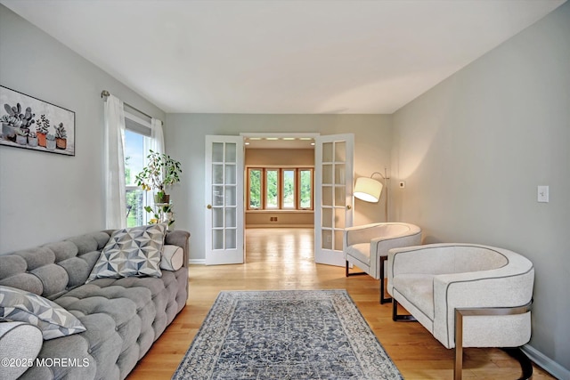 2 Hampton Hollow Dr, Perrineville, NJ 08535 - living area with french doors, plenty of natural light, light wood-style flooring, and baseboards