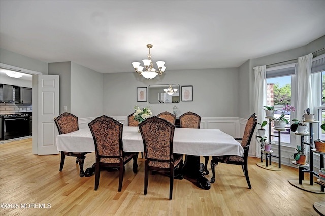 2 Hampton Hollow Dr, Perrineville, NJ 08535 - dining space featuring a chandelier, light wood-style floors, a wainscoted wall, and a decorative wall