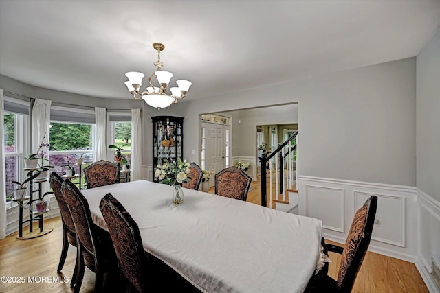 2 Hampton Hollow Dr, Perrineville, NJ 08535 - dining space featuring a chandelier, a wainscoted wall, light wood-type flooring, and stairway