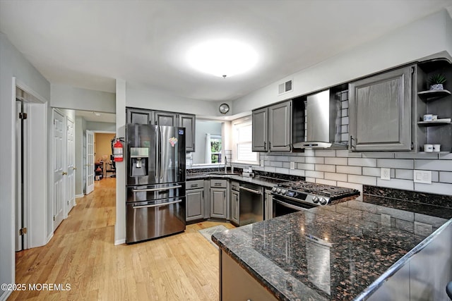 2 Hampton Hollow Dr, Perrineville, NJ 08535 - kitchen with stainless steel appliances, wall chimney range hood, gray cabinetry, open shelves, and light wood-style flooring