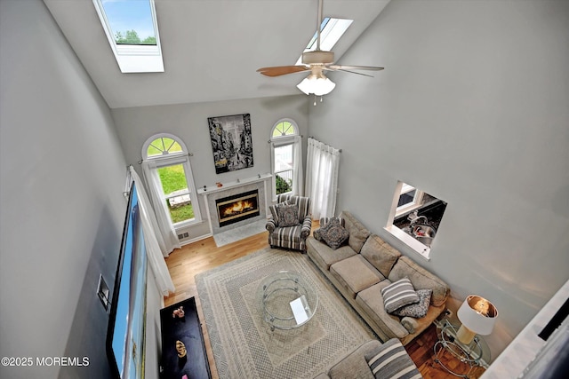 2 Hampton Hollow Dr, Perrineville, NJ 08535 - living room with high vaulted ceiling, a skylight, wood finished floors, a premium fireplace, and a ceiling fan