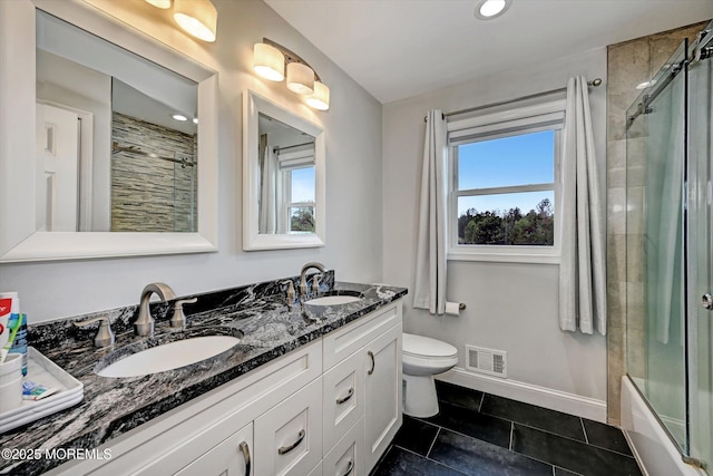 2 Hampton Hollow Dr, Perrineville, NJ 08535 - full bath with double vanity, toilet, baseboards, tile patterned floors, and shower / bath combination with glass door