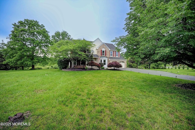 2 Hampton Hollow Dr, Perrineville, NJ 08535 - view of front facade with asphalt driveway, a front lawn, a garage, and stone siding