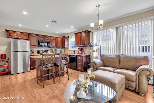 87 Prince Charles Dr, Toms River, NJ 08757 - living area with light wood-type flooring, recessed lighting, and a chandelier
