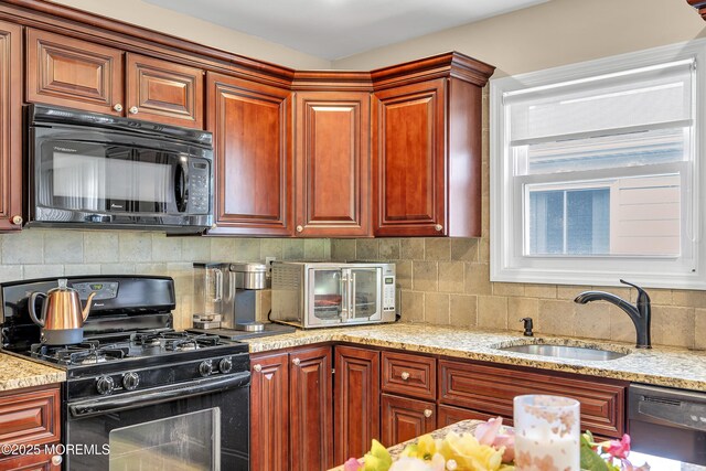 87 Prince Charles Dr, Toms River, NJ 08757 - kitchen featuring black appliances, a sink, tasteful backsplash, and light stone countertops