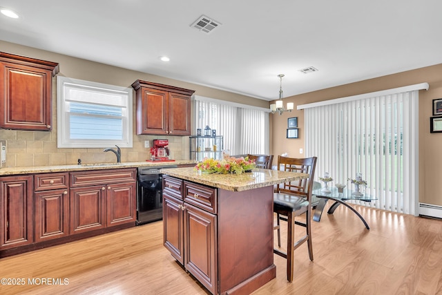 87 Prince Charles Dr, Toms River, NJ 08757 - kitchen featuring dishwasher, a kitchen breakfast bar, light wood-style floors, backsplash, and a kitchen island