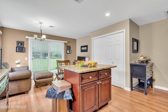 87 Prince Charles Dr, Toms River, NJ 08757 - kitchen with a chandelier, light wood-type flooring, pendant lighting, open floor plan, and a kitchen island