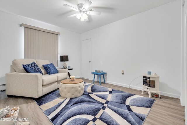 87 Prince Charles Dr, Toms River, NJ 08757 - living room with a ceiling fan, light wood-style flooring, baseboards, and a baseboard heating unit