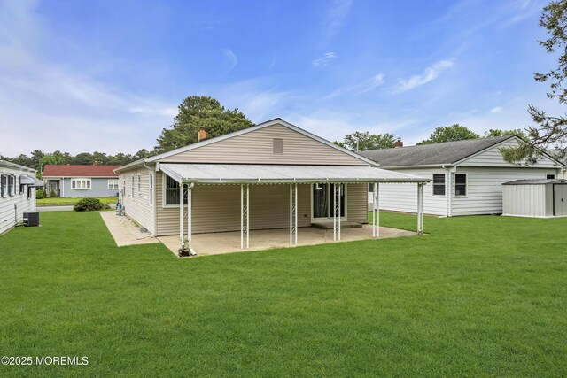 87 Prince Charles Dr, Toms River, NJ 08757 - back of property with a patio area, a lawn, and central AC unit