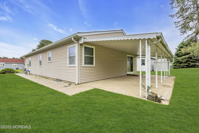 87 Prince Charles Dr, Toms River, NJ 08757 - back of property with an attached carport, a lawn, a patio area, and crawl space