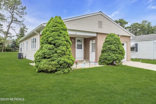 87 Prince Charles Dr, Toms River, NJ 08757 - view of front of house featuring a front yard, concrete driveway, and central air condition unit