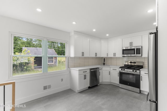 23 Drexel Dr, Jackson, NJ 08527 - kitchen with appliances with stainless steel finishes, light countertops, a sink, decorative backsplash, and white cabinetry