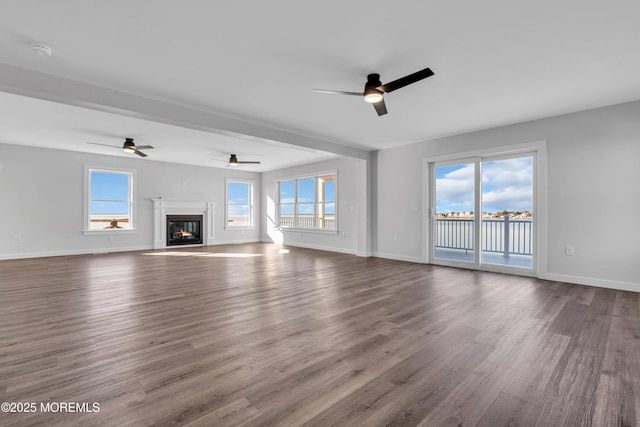 231 Cedar Island Dr, Brick, NJ 08723 - unfurnished living room with a ceiling fan, dark wood-style floors, a water view, and baseboards